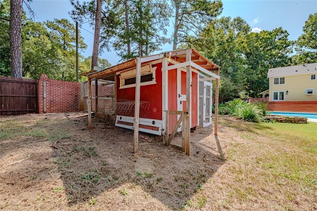 view of outdoor structure featuring a lawn