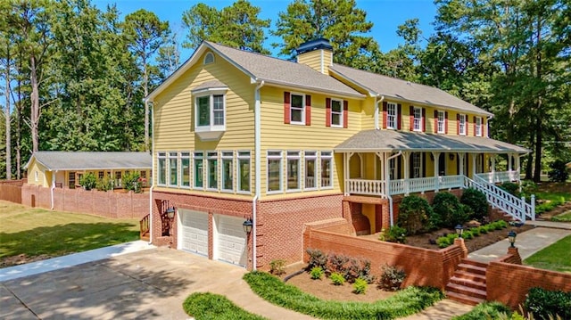 view of front of property with a porch and a garage