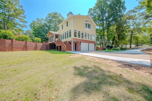 back of property with a yard and a garage