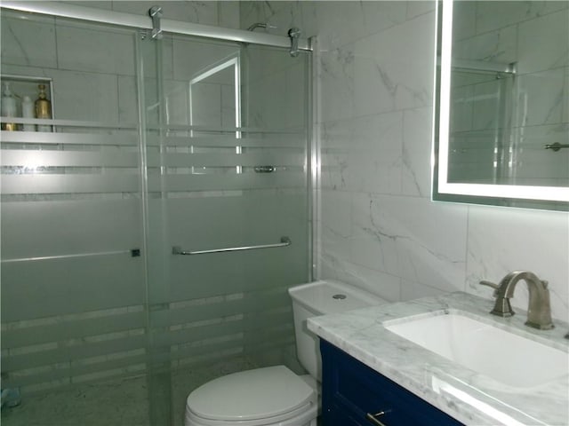 bathroom with toilet, vanity, tile walls, tasteful backsplash, and a stall shower