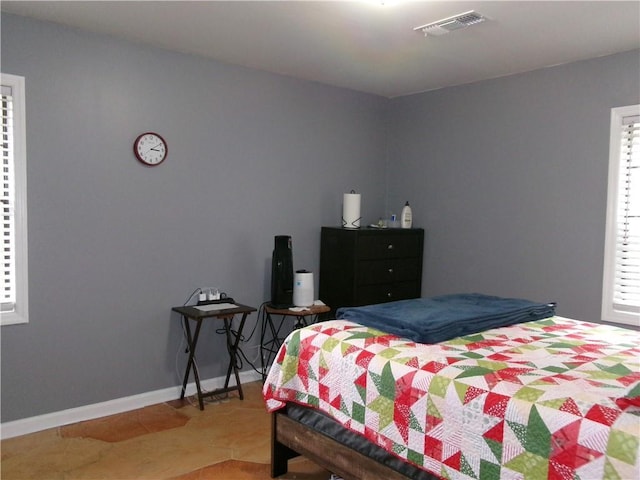 bedroom featuring baseboards, visible vents, and tile patterned floors