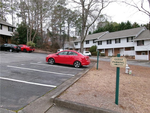 uncovered parking lot featuring a residential view