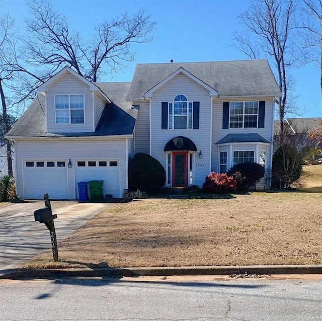 view of front facade with a garage and a front yard