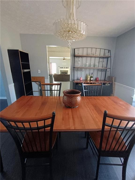 dining area with a notable chandelier and a textured ceiling