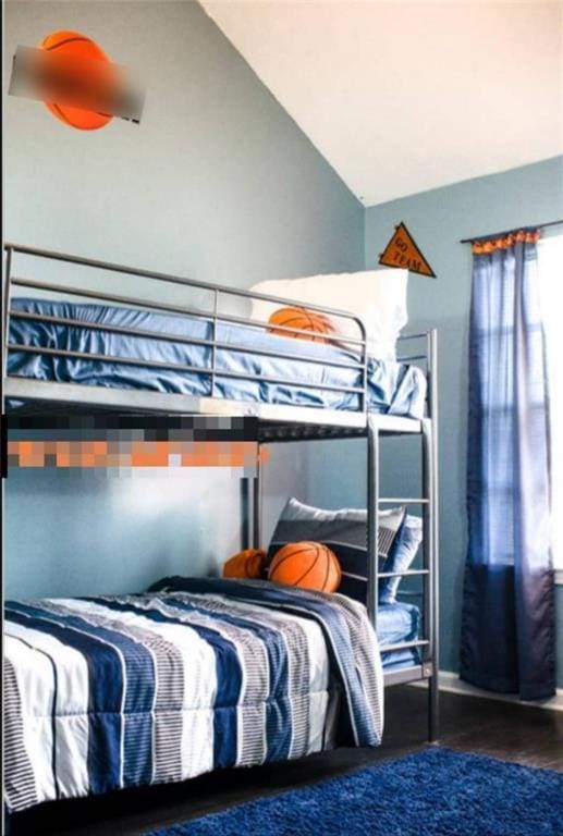 bedroom with dark hardwood / wood-style flooring and lofted ceiling