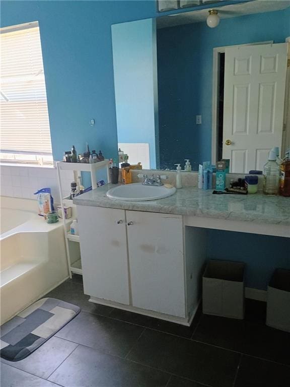 bathroom with tile patterned flooring, vanity, and a bathtub