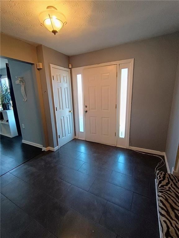 entryway featuring a textured ceiling