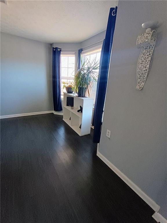 spare room with dark hardwood / wood-style flooring and a textured ceiling