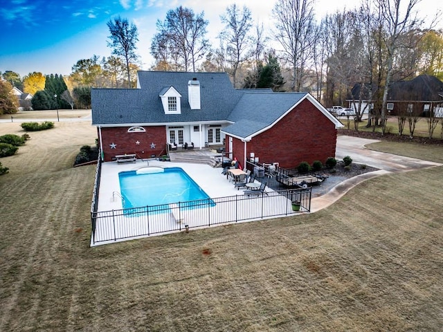 view of swimming pool featuring a patio area, french doors, and a lawn