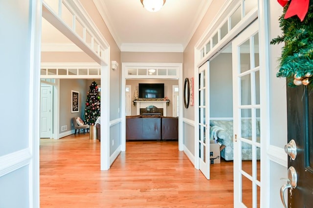 interior space with hardwood / wood-style floors, crown molding, and french doors