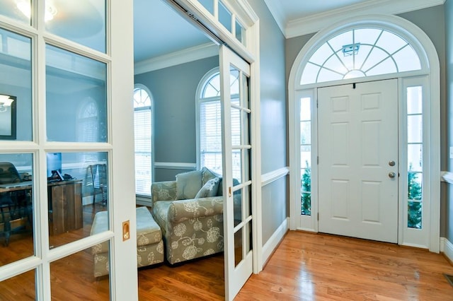 foyer featuring hardwood / wood-style flooring and ornamental molding