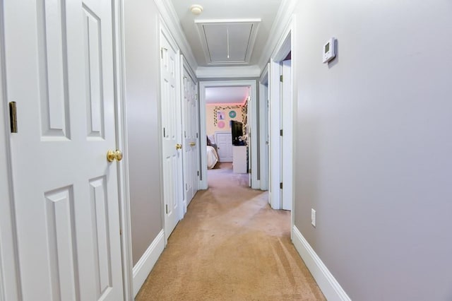 corridor featuring light colored carpet and ornamental molding