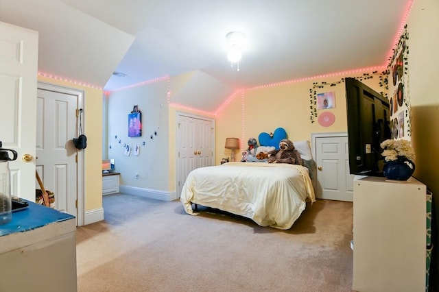 bedroom featuring lofted ceiling and light carpet