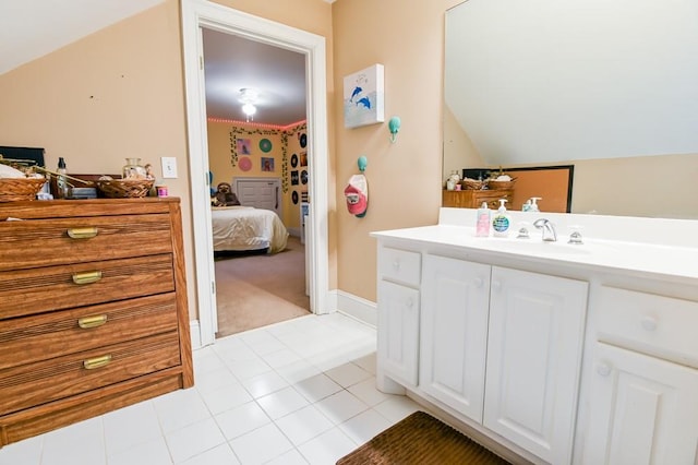 bathroom featuring lofted ceiling, vanity, and tile patterned floors