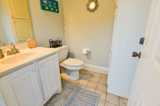 bathroom with vanity, tile patterned floors, and toilet