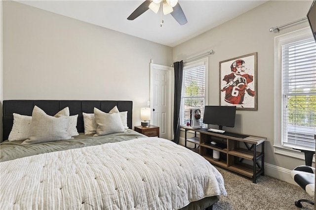 carpeted bedroom featuring baseboards and a ceiling fan