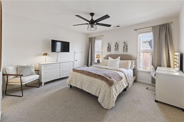 bedroom featuring light carpet, visible vents, baseboards, and a ceiling fan