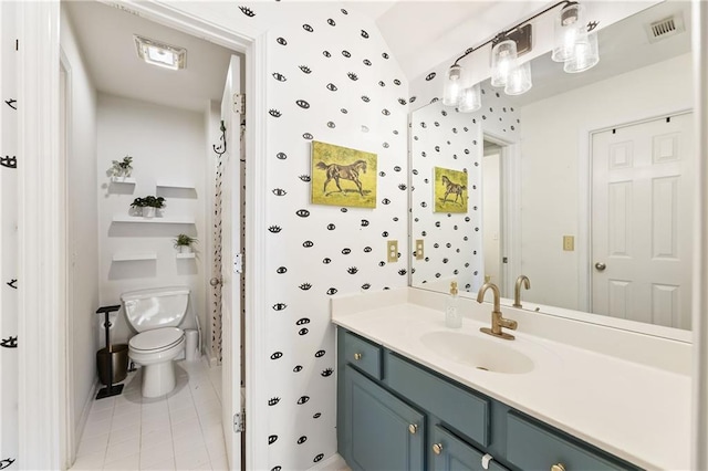 bathroom with visible vents, toilet, vanity, and tile patterned flooring