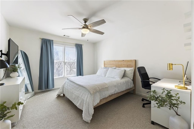 carpeted bedroom featuring visible vents, baseboards, and ceiling fan