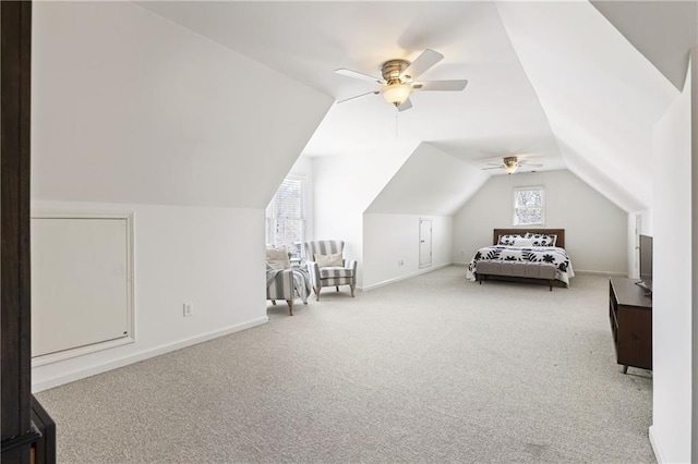 unfurnished bedroom with baseboards, carpet, ceiling fan, and vaulted ceiling