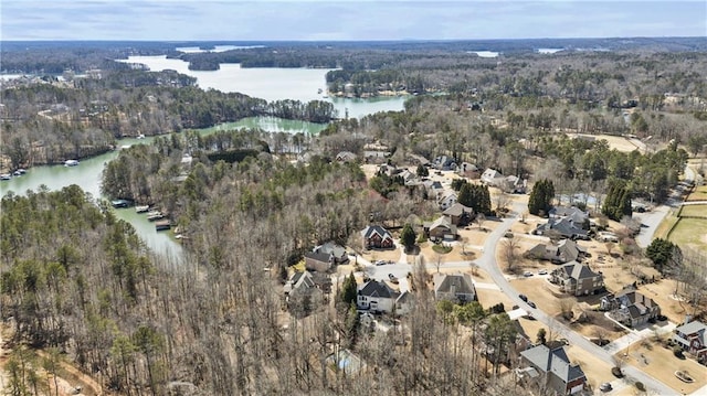 drone / aerial view featuring a water view and a wooded view