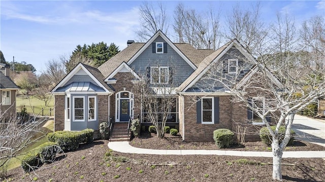 craftsman inspired home with concrete driveway, a garage, and brick siding