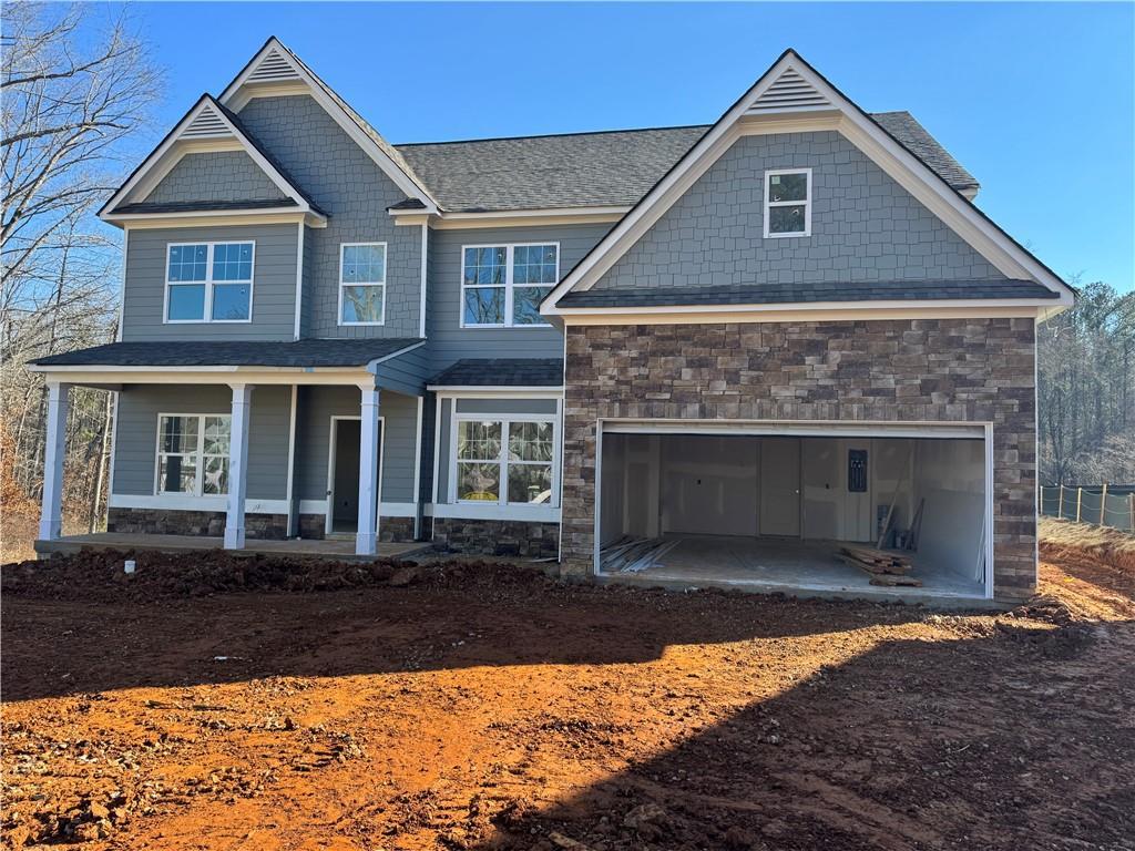 craftsman inspired home with covered porch and a garage