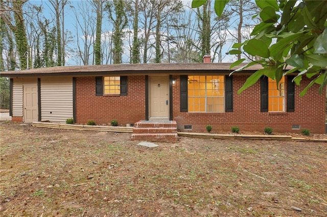 single story home featuring crawl space, a chimney, and brick siding