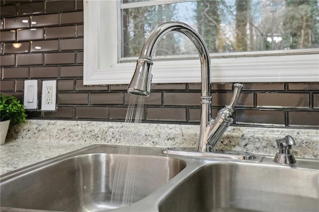 interior details featuring light countertops and a sink