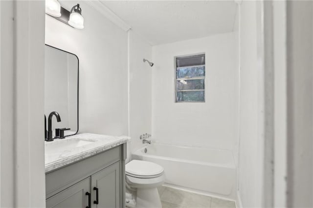 bathroom featuring tile patterned flooring, toilet, vanity, and bathtub / shower combination