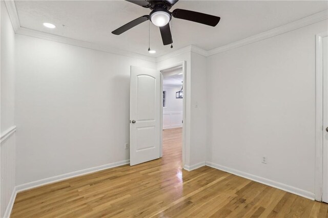 half bathroom with vanity, baseboards, and wood finished floors