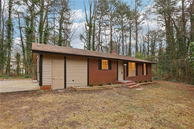 ranch-style house with brick siding and a chimney