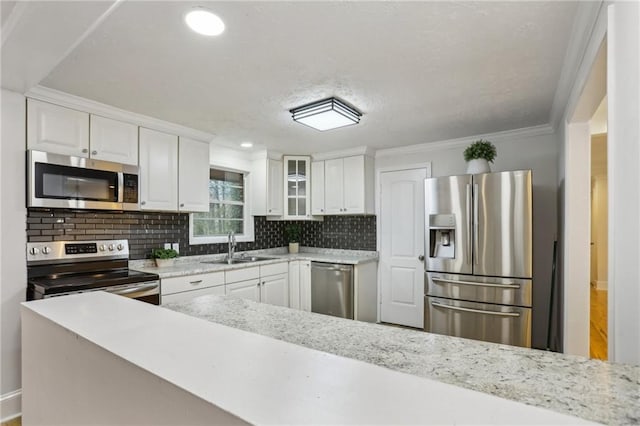 kitchen featuring white cabinets, appliances with stainless steel finishes, and a sink