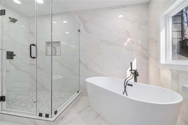 bathroom featuring plus walk in shower and tile walls