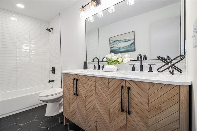 full bathroom featuring vanity, tiled shower / bath combo, tile patterned floors, and toilet