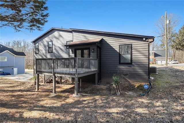 back of property with central AC and a deck