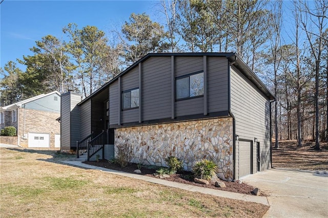 view of home's exterior with a garage and a yard