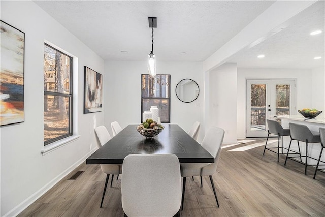 dining area with french doors and hardwood / wood-style flooring