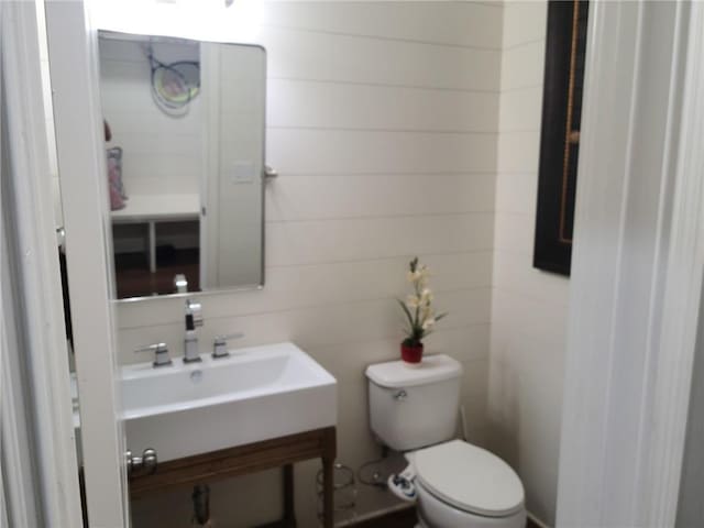 bathroom with toilet and vanity with extensive cabinet space