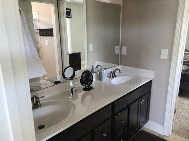 bathroom with dual sinks, oversized vanity, and tile flooring