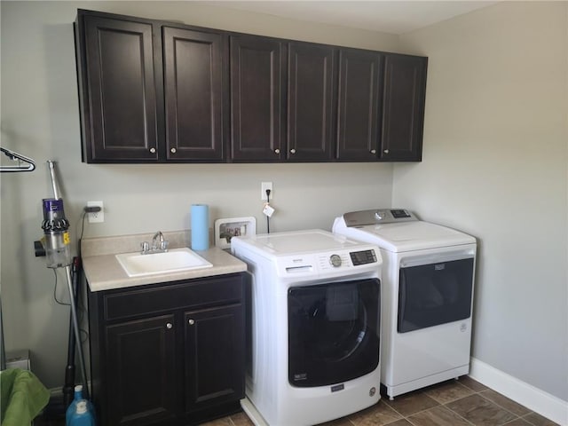 clothes washing area featuring sink, dark tile flooring, hookup for a washing machine, cabinets, and separate washer and dryer