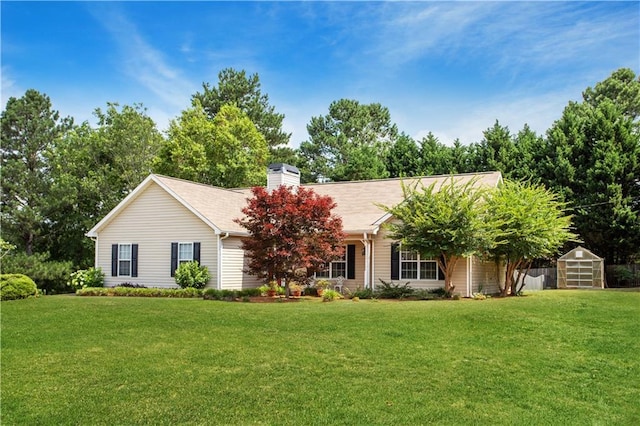 ranch-style house with a storage shed and a front yard