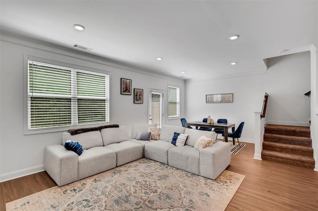 living room with ornamental molding and hardwood / wood-style floors