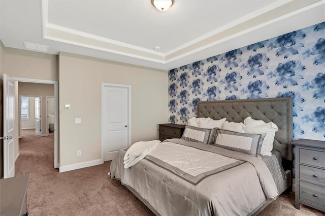 bedroom featuring a raised ceiling and carpet flooring