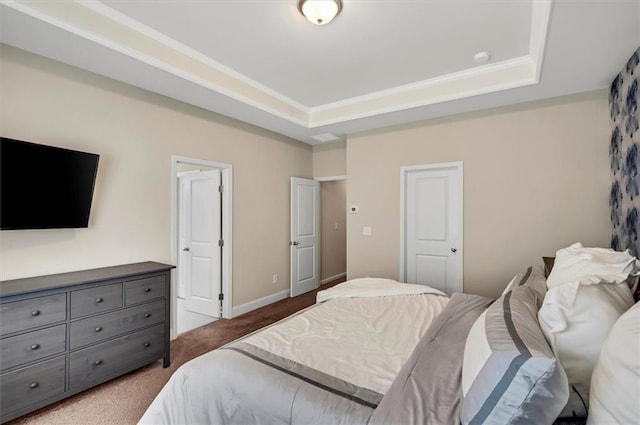 carpeted bedroom featuring a tray ceiling