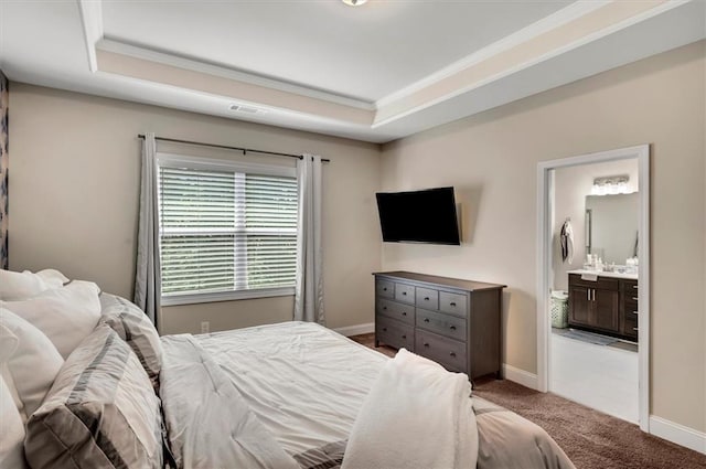 bedroom with crown molding, ensuite bath, carpet floors, and a raised ceiling