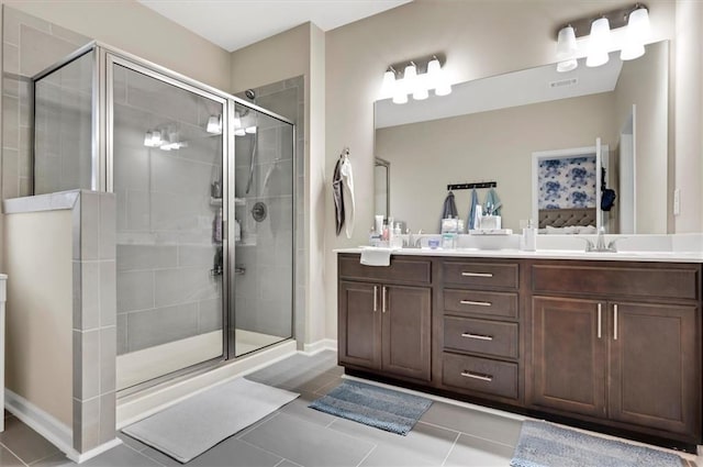 bathroom featuring tile patterned flooring, vanity, and an enclosed shower