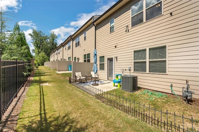 back of property with an outdoor hangout area, a lawn, central AC unit, and a patio area