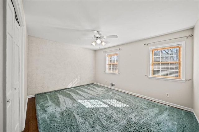 unfurnished bedroom featuring baseboards, a closet, visible vents, and a ceiling fan