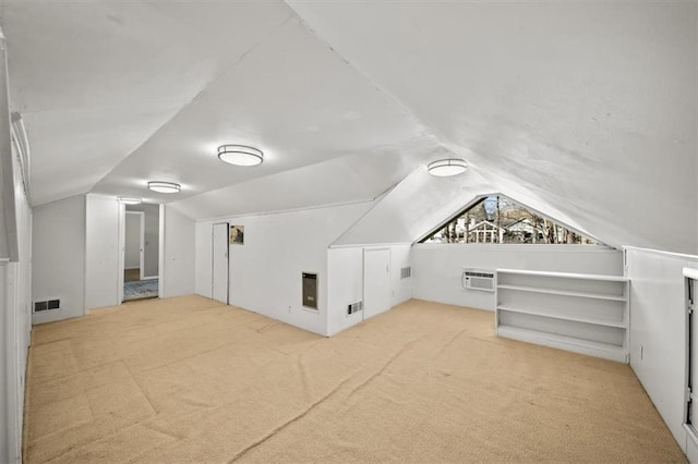 additional living space featuring lofted ceiling, carpet, and visible vents